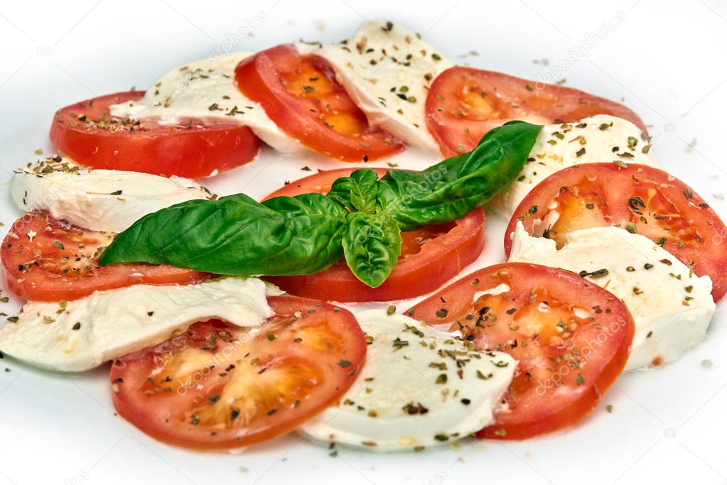 Mozzarela buffala alla caprese, classic italian appertizer, Mozzarella with tomatoes served on white plate, isolated on white background