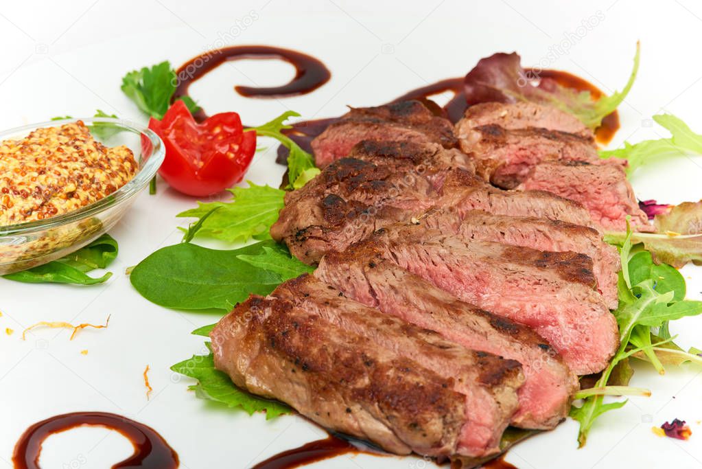 Italian food, Sirloin steak of beef with ancient mustard served on white plate, isolated on white background