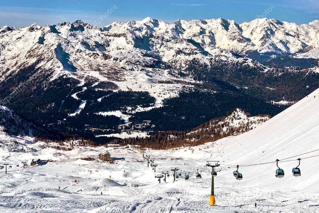 Beautiful winter mountains landscape Ski lift Ski resort in italy, The ski slope and skiers at Passo Groste ski area