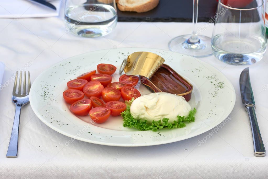 Burrata cheese with cherry tomatoes and anchovies from the Sea