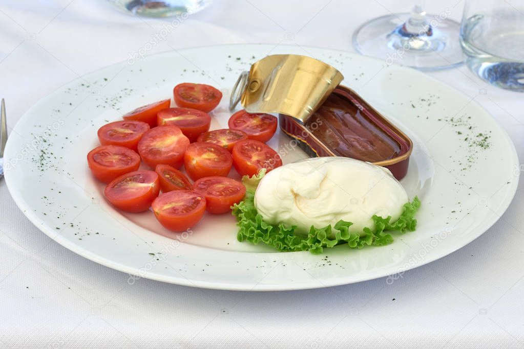 Burrata cheese with cherry tomatoes and anchovies from the Sea