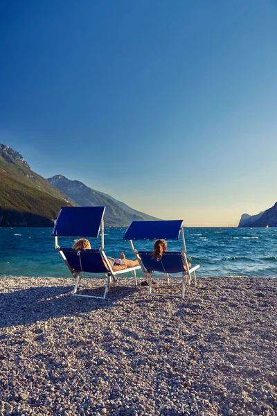 Pessoas Sentadas Praia Espreguiçadeira Admirando Lago Garda Verão Vista Belo — Fotografia de Stock