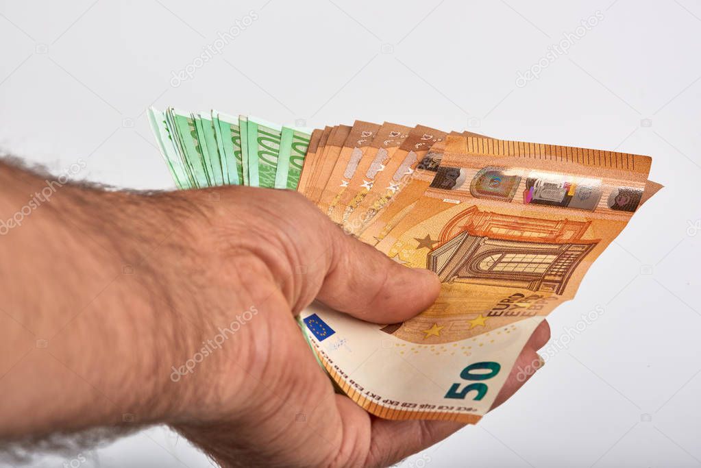 Man hand with money isolated on white background