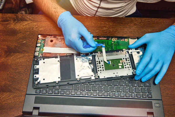 Hands of the technician repairing a computer, Professional laptop repair,Close up with selective focus