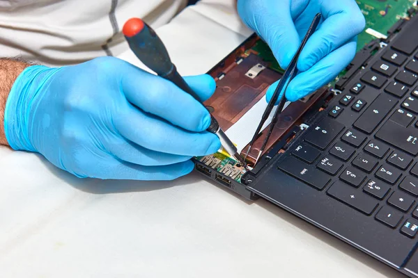 Hands of the technician repairing a computer, Professional laptop repair,Close up with selective focus