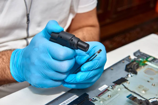 Hands of the technician repairing a computer, Professional laptop repair,Close up with selective focus