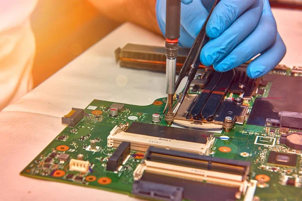 Hands of the technician repairing a computer, Technician who changes the computer\'s processor, Close up with selective focus