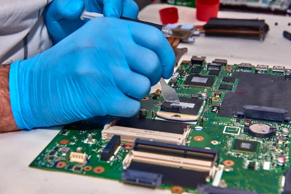 Hands of the technician repairing a computer, Technician who changes the computer\'s processor, Close up with selective focus