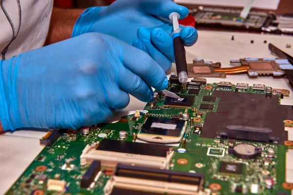 Hands of the technician repairing a computer, Technician who changes the computer\'s processor, Close up with selective focus