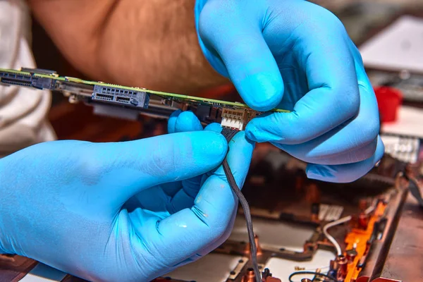 Hands of the technician repairing a computer, Professional laptop repair,Close up with selective focus