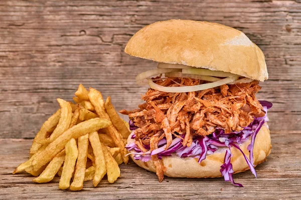 Barbekü çekti domuz sandviç ile barbekü sosu, kırmızı cabbageonion, sos ve patates salatası ahşap arka plan, Fast food
