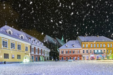 Brasov, Romania- 06 January 2019:Christmas Tree in the old city center of Brasov in a snowing night,Panoramic view of the old town and  Council Square