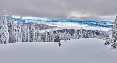 Kayak pisti Poiana Brasov kayak merkezi Transylvania'da, kış sezon, kışın dağ manzarası içinde belgili tanımlık geçmiş Bucegi Dağları ile karla kaplı çam ormanı üzerinden panoramik görünüm
