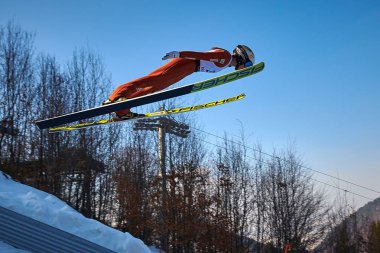 Rasnov, Romania - 25-27 January 2019: Unknown ski jumper competes in the FIS Ski Jumping World Cup on February 25-27 January 2019 in Rasnov, Romania clipart