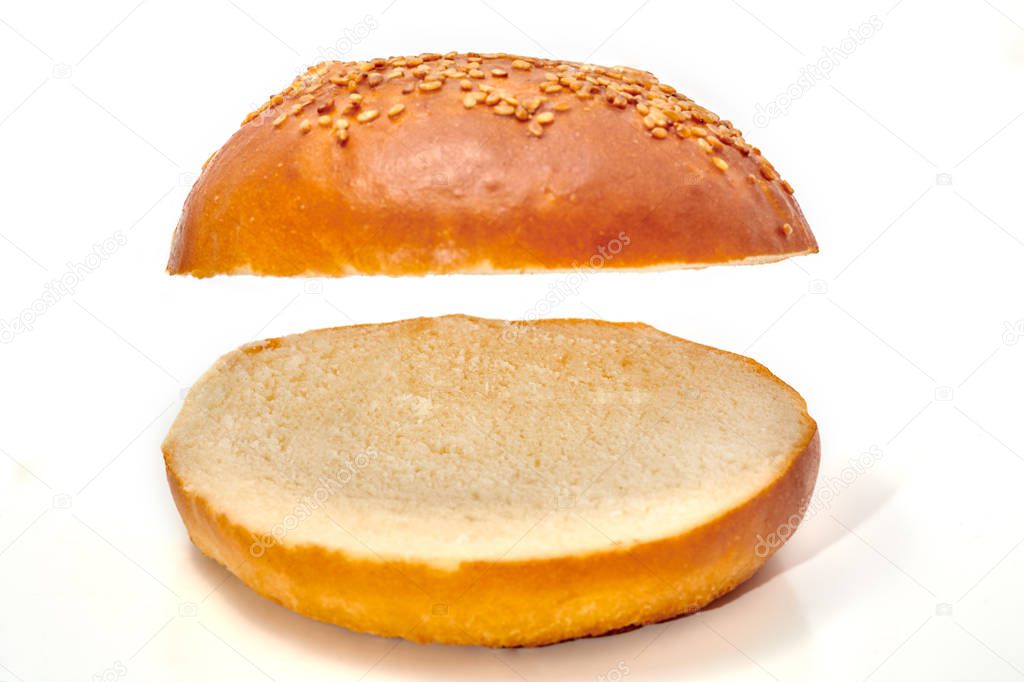 Burger bun cut in two isolated on white background