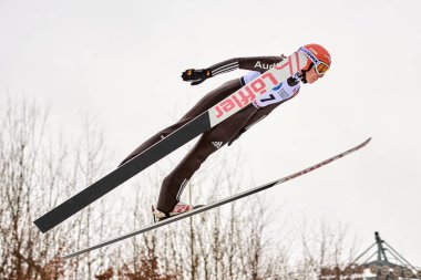 Rasnov, Romania - 3 March 2018: Unknown ski jumper compets to win the Ladies' FIS World Cup Ski Jumping event in Rasnov, Romania clipart