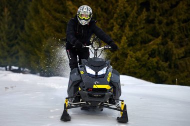 Tusnad, Romanya - 02 Şubat 2019: bir adam dağlarda, kar arabası Tusnad, Romanya'da snowmobile sürüş adam biniyor