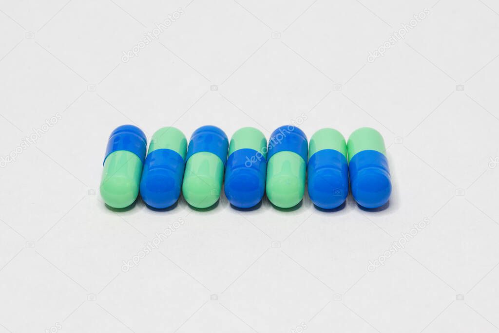 Medicine Pills. Tablets. Capsule.Pharmaceutical medicament, Close-up of pile of blue and green tablets - capsule. Pills and tablets on white background