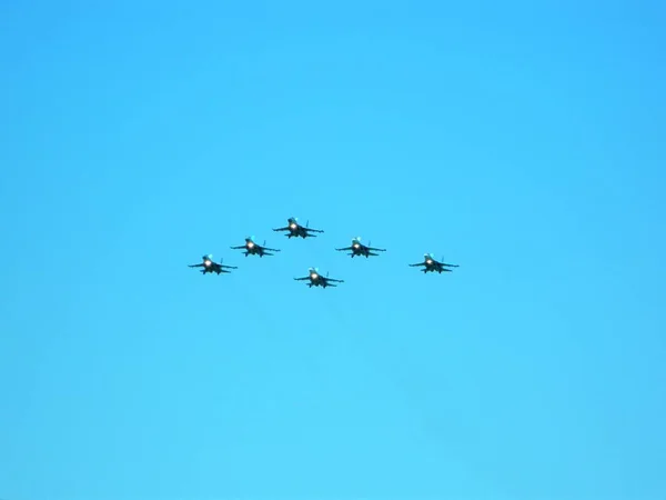 A group of military aircraft flies in formation at air shows