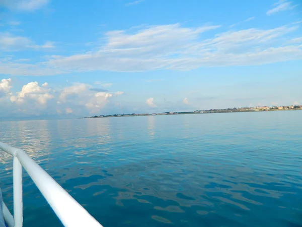 View from the boat sailing on a calm sea. Complete calm.