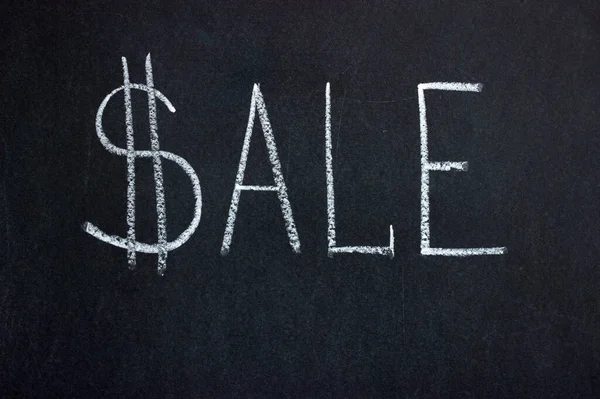 The inscription on the chalk board SALE with a dollar sign