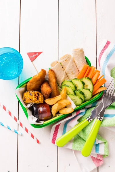 Picnic lunch box with chicken, fries, tortilla and vegetables — Stock Photo, Image