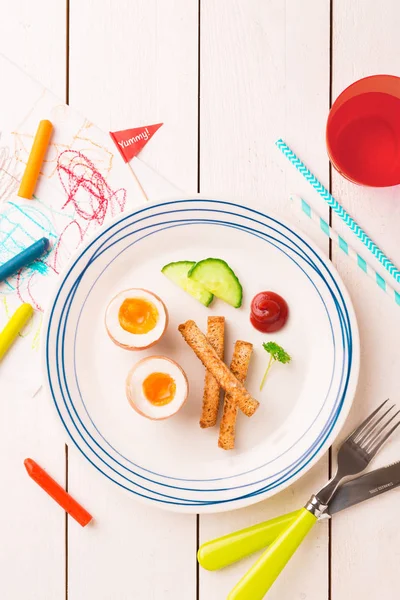 Kid's breakfast - eggs, toasts, cucumber and ketchup — Stock Photo, Image
