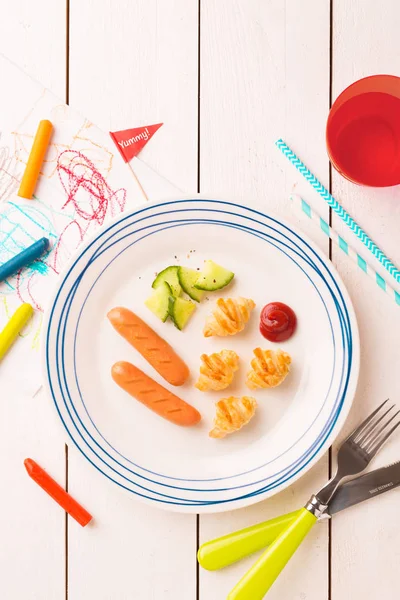 Kid's breakfast - weenies, mini croissants and cucumber — Stock Photo, Image