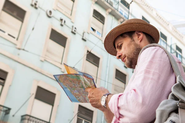 Tourist man looking at the city map - summer holiday traveling