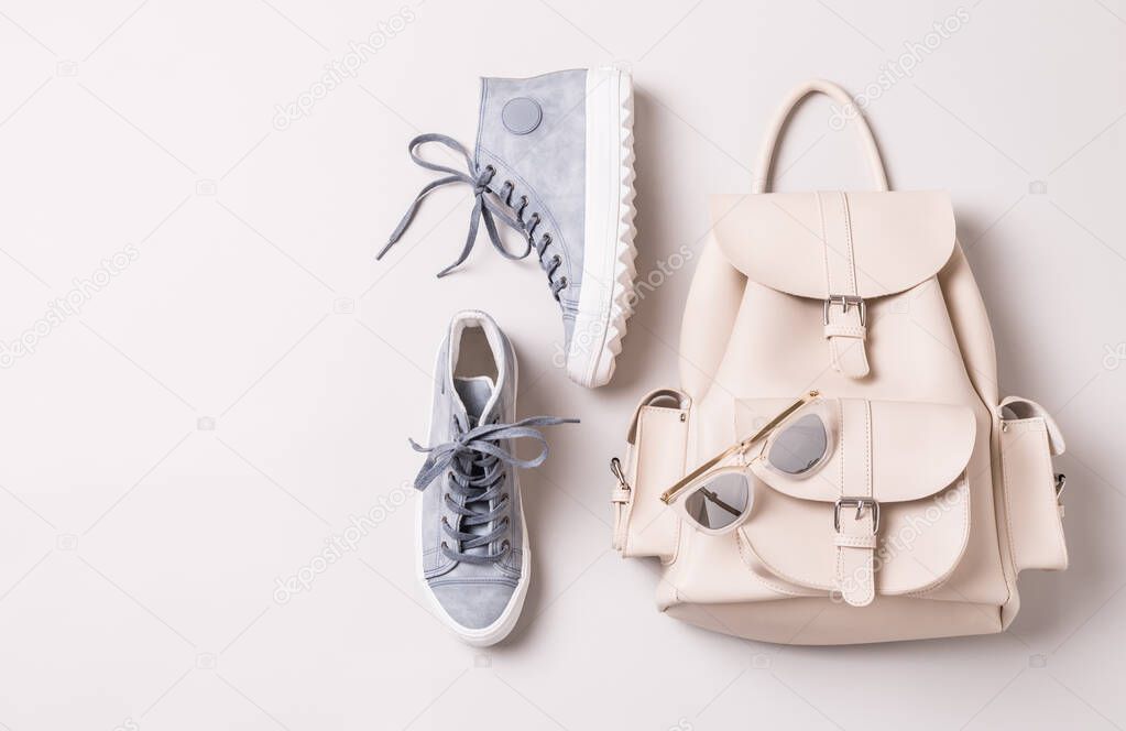 White backpack and pastel blue sneakers - fashion accessories