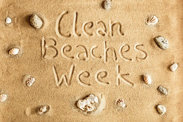 Clean beaches week - eco initiative name on the golden sand. Ecology - poster concept.