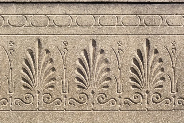 Engraved floral ornament on a stone surface