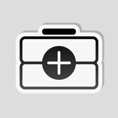 ilk yardım çantası, anahat simgesi. Etiket tarzı ile beyaz ve gri arka plan üzerinde basit gölge