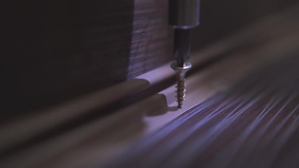 Master who produces furniture fastens the plinth to the surface of the table using a screwdriver. Close-up — Stock Footage Master who produces furniture fastens the plinth to the surface of the table using a screwdriver. Close-up Royalty Free Stock Video