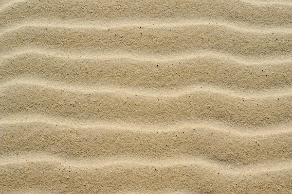 Fondo texturizado de hermosa arena marina de color amarillo ondulado . — Foto de Stock