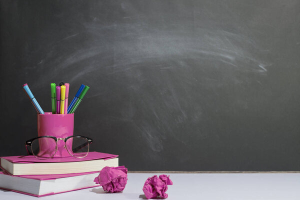 Books and stationery are placed on the table