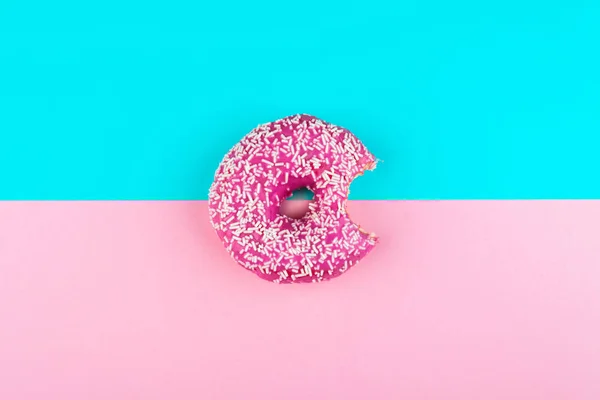 Ein rosa isolierter Donut auf mint und rosa Hintergrund — Stockfoto