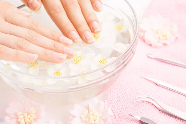 Beautiful woman hands with french manicure and instruments — Stock Photo, Image