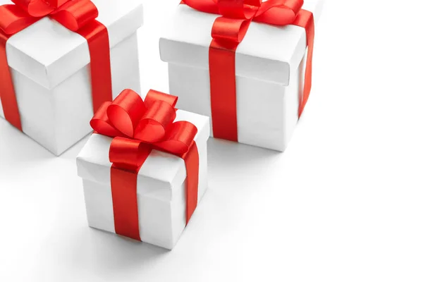 Three gift boxes with red ribbons on white background — Stock Photo, Image