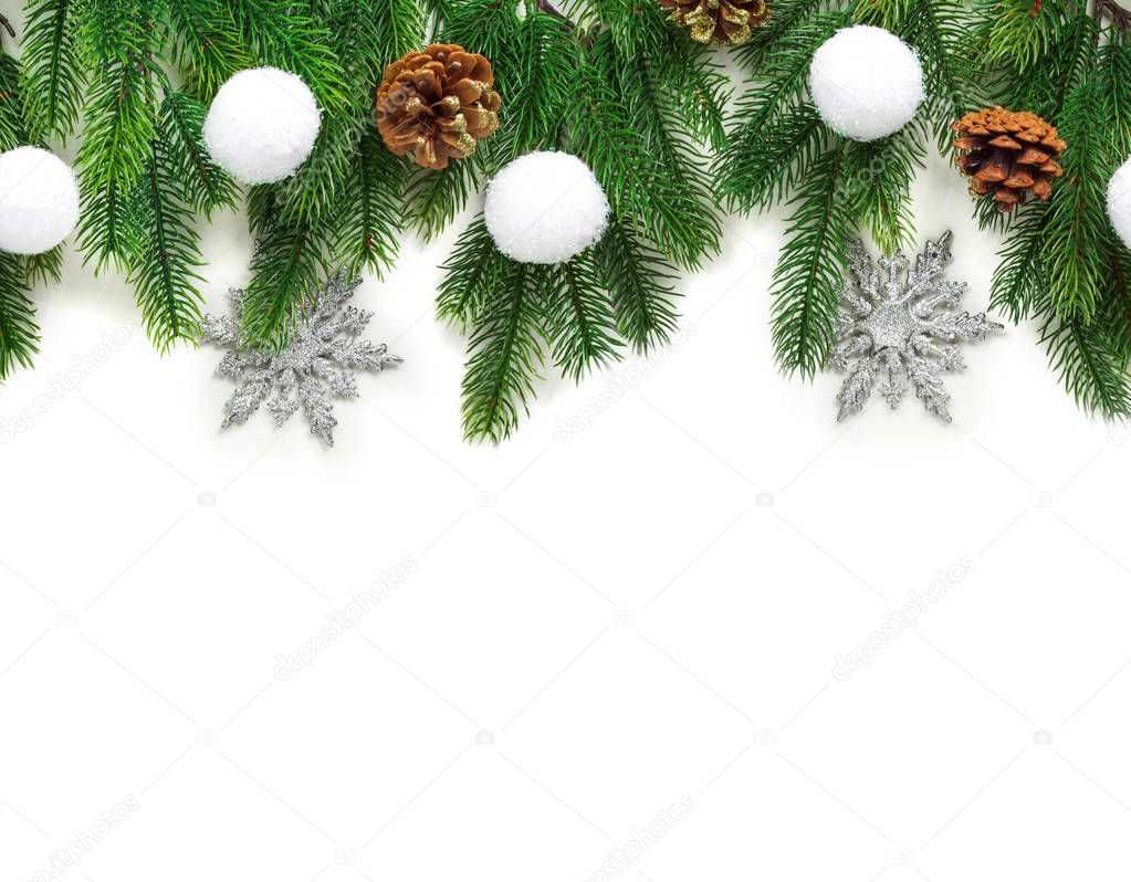 Christmas tree branches with decoration isolated on white background.