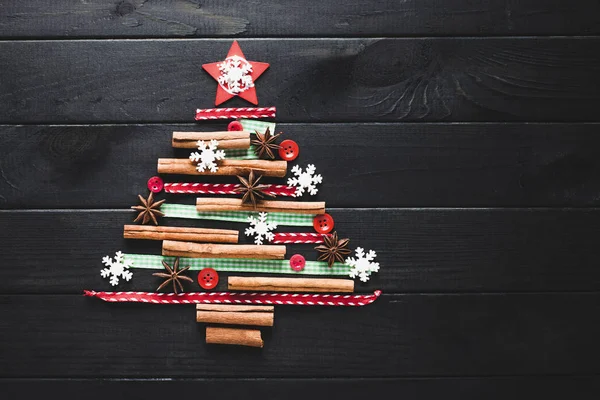 Kerstboom gemaakt van kaneel, anijs, linten en knoppen — Stockfoto