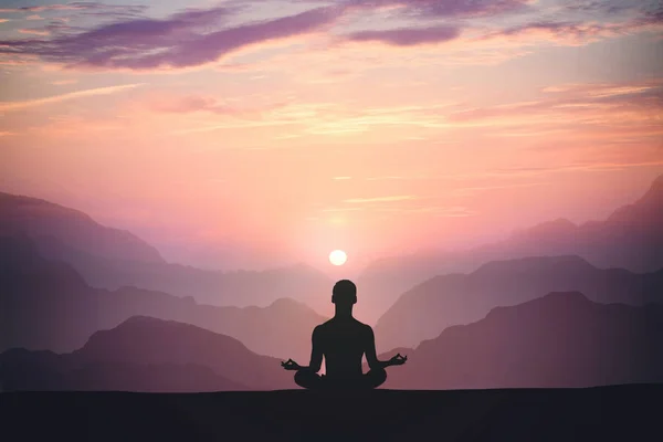 Man practices yoga and meditates on the mountain. — Stock Photo, Image