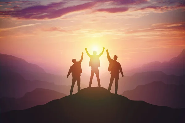 Silhouette of the team on the mountain — Stock Photo, Image