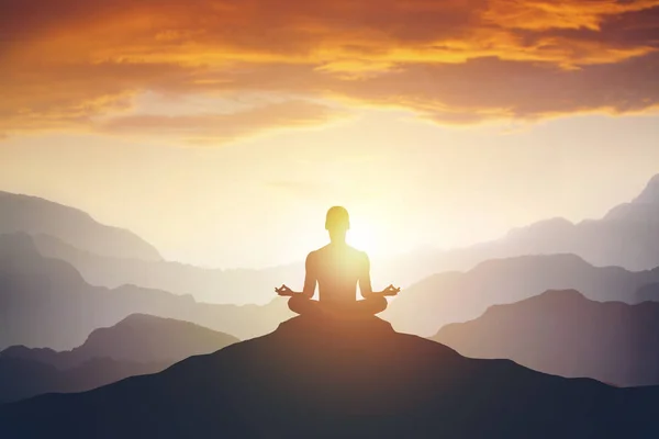 Silhouette of the meditaion man on the mountain — Stock Photo, Image