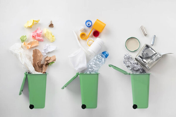 top view of trash bins and sorted garbage on grey