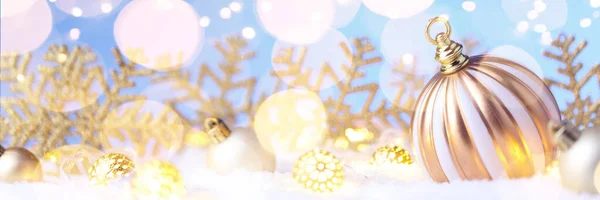 Boule décorative en or de Noël sur neige avec lumières scintillantes dorées . — Photo