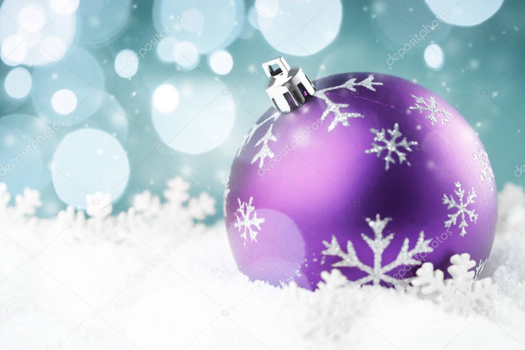 Purple christmas ball with snowflake on snow background. Merry Christmas card