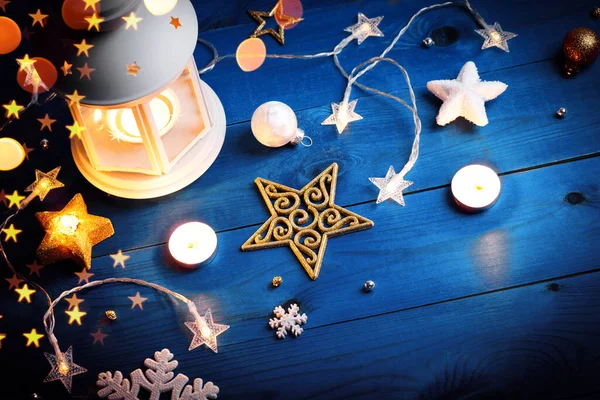 Christmas white lantern with candles and decorations on blue wooden background — Stock Photo, Image