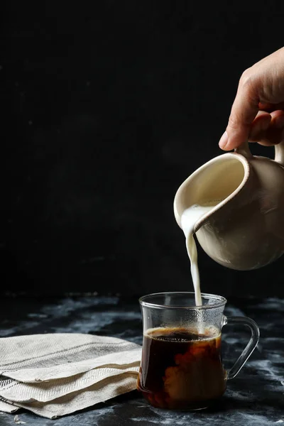 Woman Hand Pouring Milk Glass Cup Coffee — Stock Photo, Image