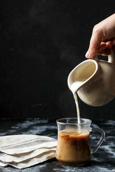 Woman Hand Pouring Milk Glass Cup Coffee — Stock Photo, Image